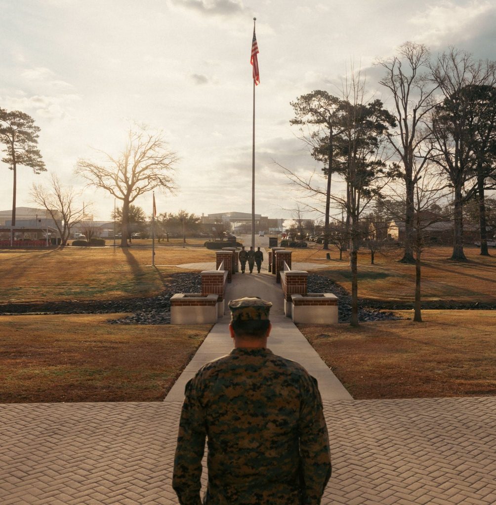 Veteran with US flag in the distance