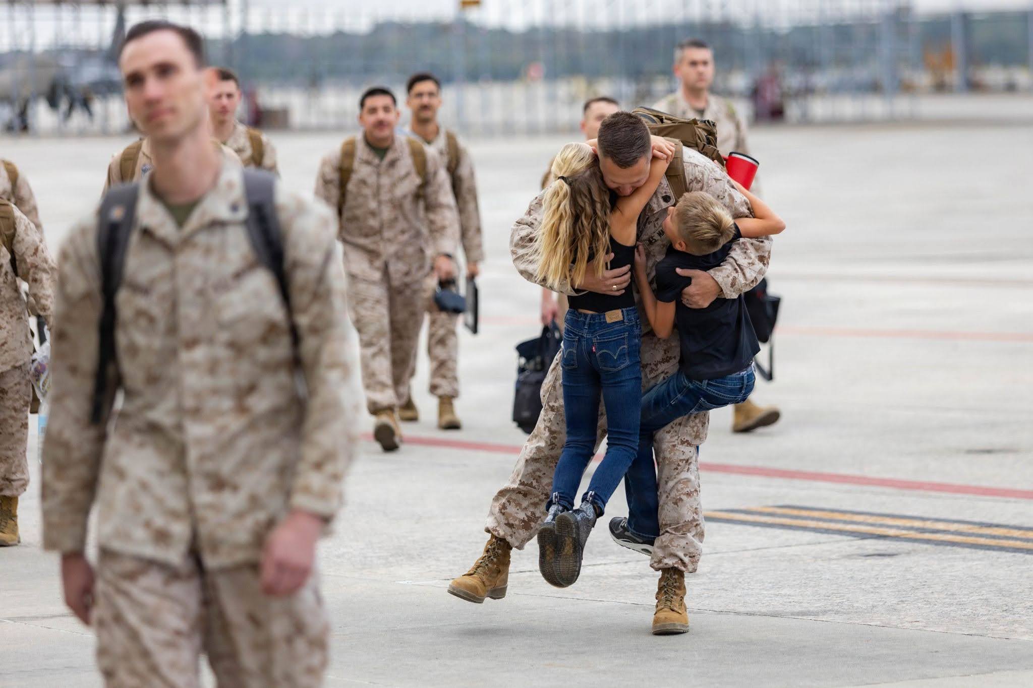 Veteran hugs family members
